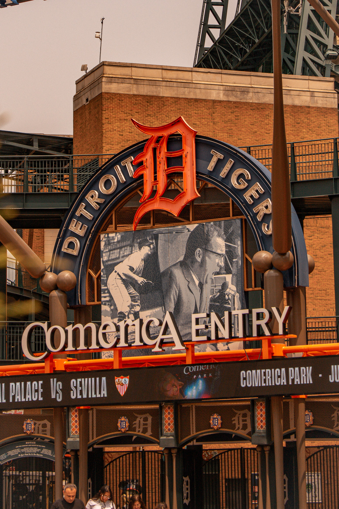 Layered Detroit street scene with people and traffic
